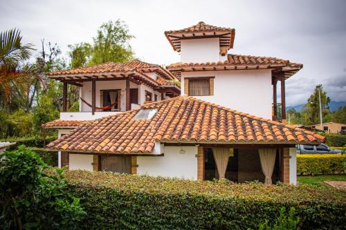 a house with a tiled roof in front at El Pozzo Hotel Campestre in Villa de Leyva