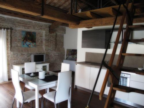 a living room with a table and chairs and a desk at Agriturismo Villa Anconetta in Loreo