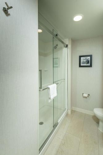 a bathroom with a glass shower with a toilet at Hampton Inn by Hilton Amesbury, MA in Amesbury