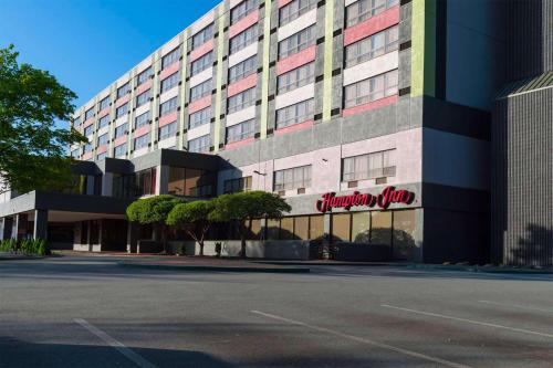 a building with a sign on the side of it at Hampton Inn Boston-Natick in Natick