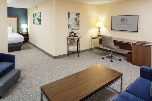 a hotel room with a bed and a desk and a room at DoubleTree by Hilton Boston-Andover in Andover