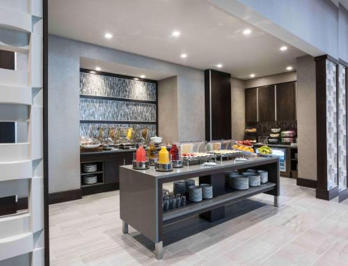 a kitchen with a counter with food on it at Hilton Garden Inn Foxborough Patriot Place in Foxborough