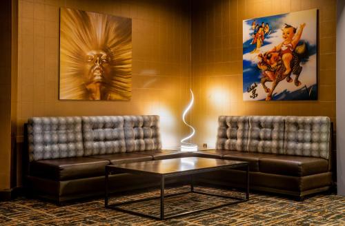 a waiting room with two leather couches and a coffee table at The Verve Boston Natick, Tapestry Collection by Hilton in Natick