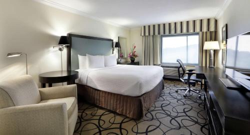 a hotel room with a bed and a desk at The Verve Boston Natick, Tapestry Collection by Hilton in Natick
