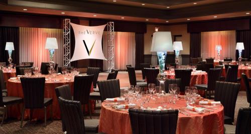 a conference room with tables and chairs with wine glasses at The Verve Boston Natick, Tapestry Collection by Hilton in Natick