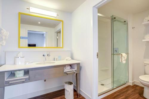 a bathroom with a sink and a shower at Hampton Inn & Suites Boston/Waltham in Waltham