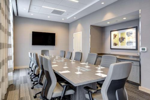 a conference room with a long table and chairs at Hampton Inn & Suites Boston/Waltham in Waltham