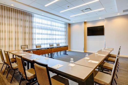 a conference room with a long table and chairs at Hampton Inn & Suites Boston/Waltham in Waltham