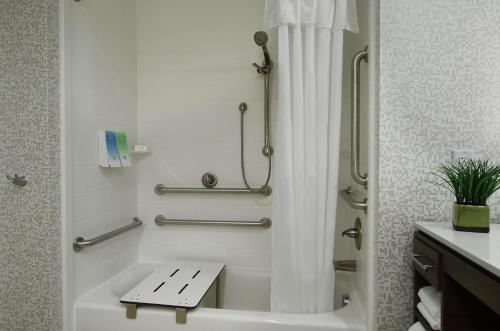 a bathroom with a shower and a bath tub with a toilet at Home2 Suites By Hilton Port Arthur in Port Arthur