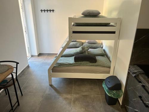 a white bunk bed in a room with towels at Hobití apartmán - Bilbo in Černá v Pošumaví