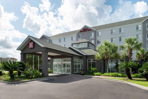 a rendering of the front of a hotel with a parking lot at Hilton Garden Inn Baton Rouge Airport in Baton Rouge