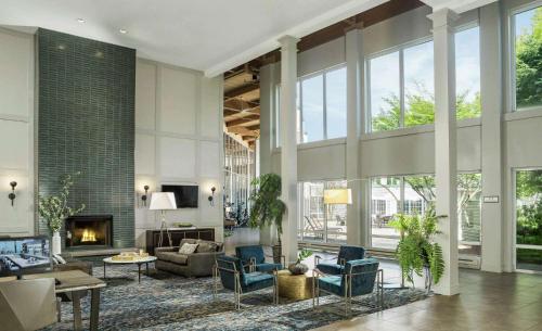 a living room filled with furniture and a fireplace at DoubleTree by Hilton Hotel Burlington Vermont in Burlington