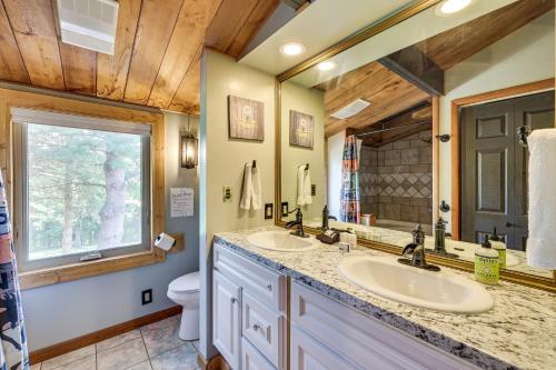 a bathroom with two sinks and a mirror at Eureka Springs Rental Cabin 8 Mi to Downtown! in Eureka Springs