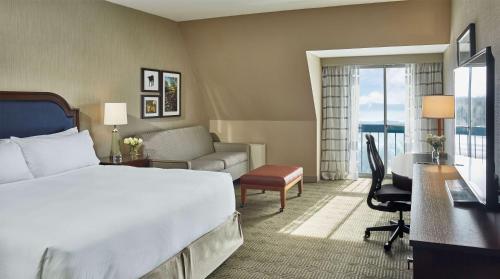 a hotel room with a bed and a desk and a room at DoubleTree by Hilton Hotel Burlington Vermont in Burlington