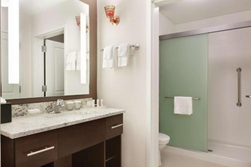 a bathroom with a sink and a toilet and a mirror at Homewood Suites by Hilton Burlington in Burlington