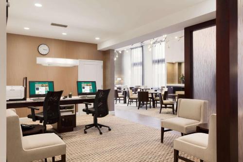 an office with a waiting room with desks and chairs at Homewood Suites by Hilton Burlington in Burlington