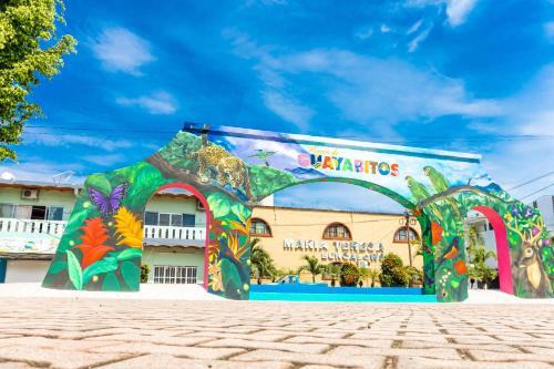 a building with a colorful mural on it at Bungalows Maria Teresa in Rincon de Guayabitos