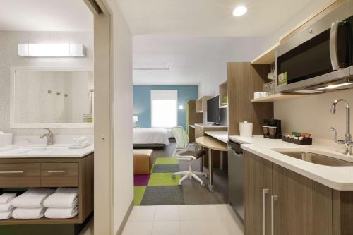 威廉斯維爾的住宿－Home2 Suites By Hilton Williamsville Buffalo Airport，一间带水槽的浴室和一间房间