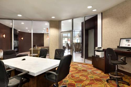 a conference room with a table and chairs and a computer at Embassy Suites Los Angeles Glendale in Glendale