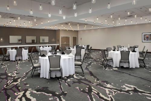 a banquet hall with white tables and chairs at Hilton Garden Inn Columbia Airport, SC in Columbia