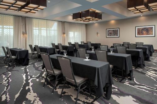 a conference room with black tables and chairs at Hilton Garden Inn Columbia Airport, SC in Columbia