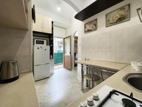 a kitchen with a sink and a counter top at Austrian Lviv Apartments in Lviv