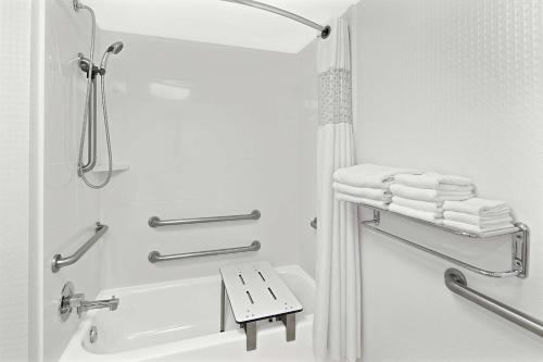 a bathroom with a shower and a sink and towels at Hampton Inn Atlanta-Newnan in Newnan