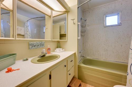 a bathroom with a sink and a bath tub at Rustic Mauston Retreat Walk to Castle Rock Lake in Mauston