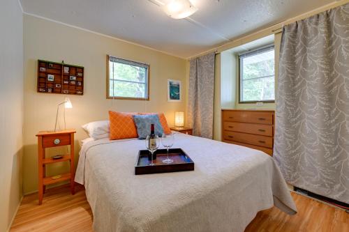 ein Schlafzimmer mit einem Bett und einem Tablett darauf in der Unterkunft Rustic Mauston Retreat Walk to Castle Rock Lake in Mauston