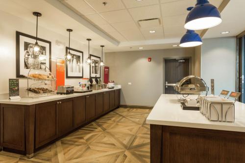 a waiting room at a hospital with a hair salon at Hampton Inn Cumberland in Cumberland