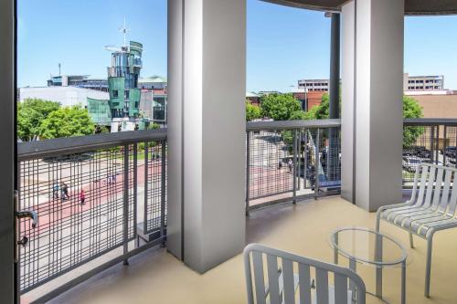 a balcony with two chairs and a view of the city at Hampton Inn & Suites Chattanooga Downtown in Chattanooga