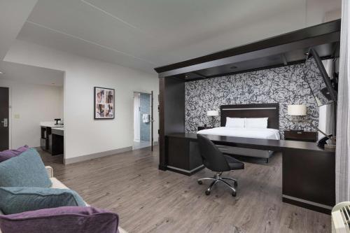 a hotel room with a bed and a desk at Hampton Inn & Suites Chattanooga Downtown in Chattanooga