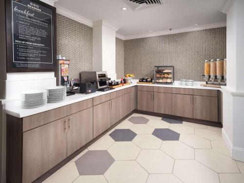 a restaurant with a counter with plates on it at Hilton Garden Inn Chattanooga Downtown in Chattanooga