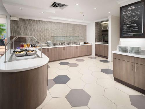 a restaurant with a counter with dishes on it at Hilton Garden Inn Chattanooga Downtown in Chattanooga