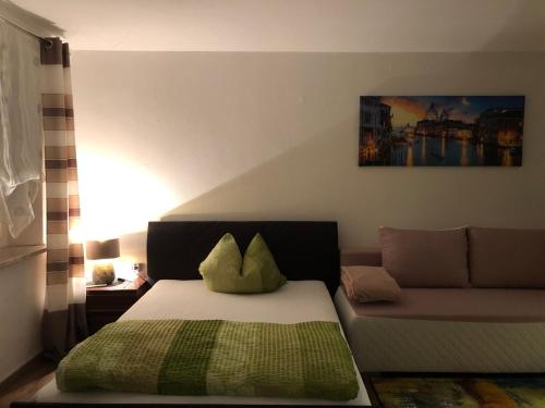 a bedroom with a bed and a couch at Fine Ferienwohnung in City in Bayreuth