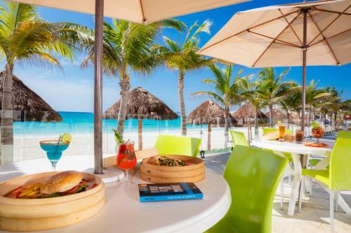 a table with a meal on the beach at Krystal Cancun in Cancún