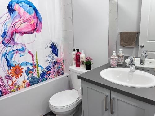 a bathroom with a toilet and a sink at Private Entire Townhouse Retreat Close to Lake in Calgary