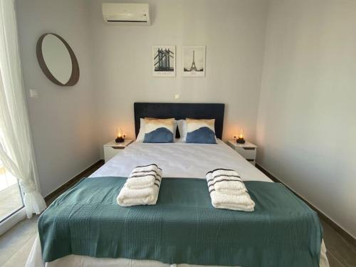 a bedroom with a large bed with two pillows on it at Dimofontas - Hub Thiseio & Gkazi in Athens