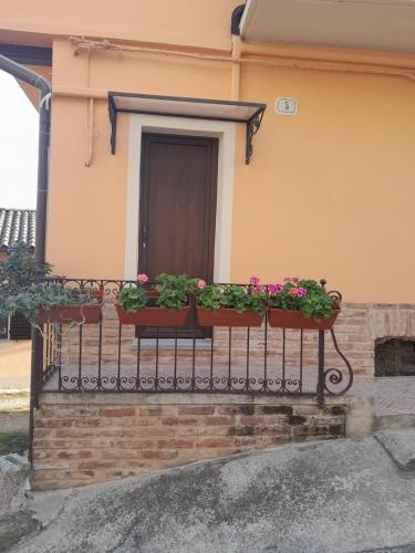 a balcony with two benches with flowers on it at La Casetta di Treville in Ozzano Monferrato