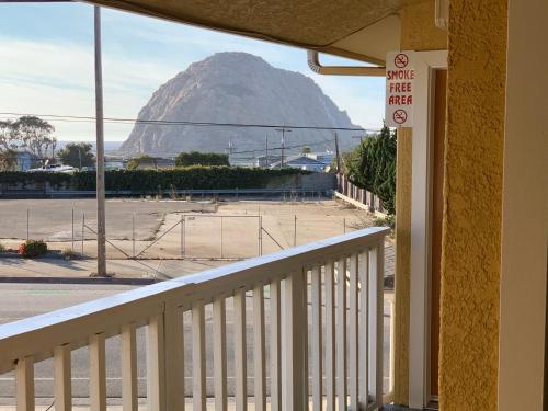 a balcony with a view of a mountain at Morro Bay Beach Inn in Morro Bay