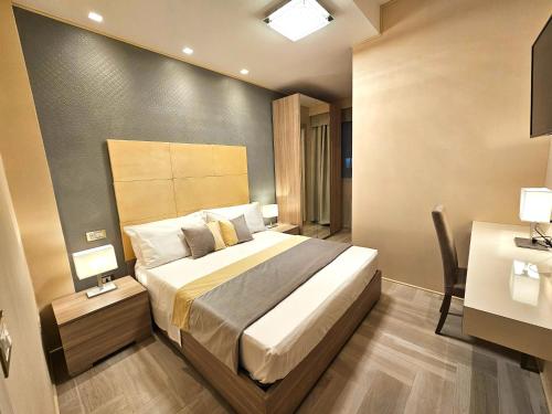a bedroom with a large bed and a desk and a bed sidx sidx sidx sidx at Astoria Supreme - Modern Boutique Suites in Lecce