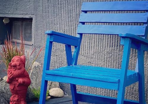a red toy dog sitting next to a blue chair at Platzhirsch in Kehl am Rhein