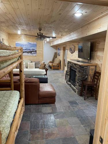a living room with a couch and a fireplace at OVERLOOK LODGE in Banner Elk