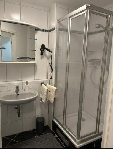 a bathroom with a shower and a sink at Detmolder Perle in Detmold
