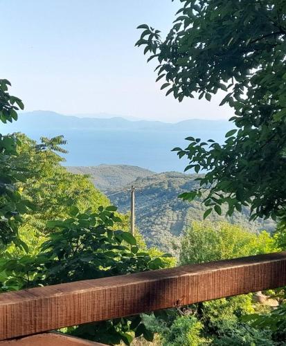 a wooden fence with a view of the mountains at Mountain and Sea view in Miléai