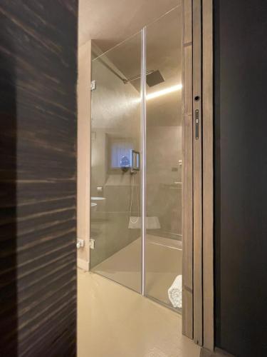 a glass door to a bathroom with a shower at La Rêverie de Thumel - Suite in Rhêmes-Notre-Dame