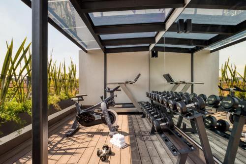 a gym with cardio equipment on the roof of a house at ULIV Roma Norte in Mexico City