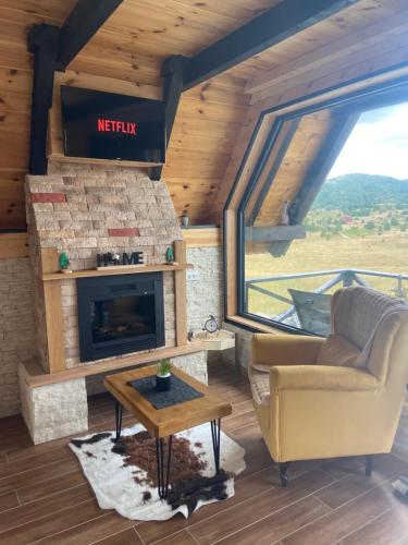 a living room with a couch and a fireplace at Runolist Chalet in Žabljak