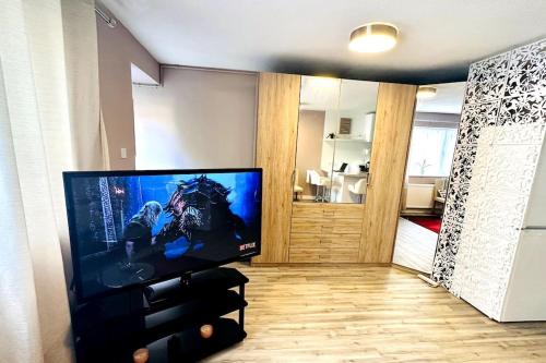 a living room with a large flat screen tv at NKN cosy maisonette close to Dartford train station, free parking, food, shopping in Kent
