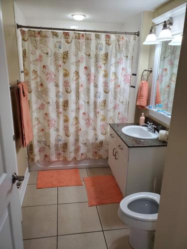 a bathroom with a toilet and a shower curtain at Grand Panama Beach Resort 1-1103 in Panama City Beach